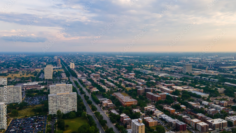 establishing aerial drone footage of a Chicago neighborhood downtown. the city beautiful architectural is also covered by lush green trees throughout creating a welcoming view for tourist