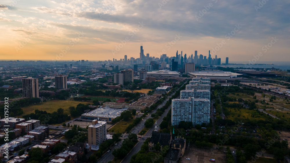 establishing aerial drone footage of a Chicago neighborhood downtown. the city beautiful architectural is also covered by lush green trees throughout creating a welcoming view for tourist