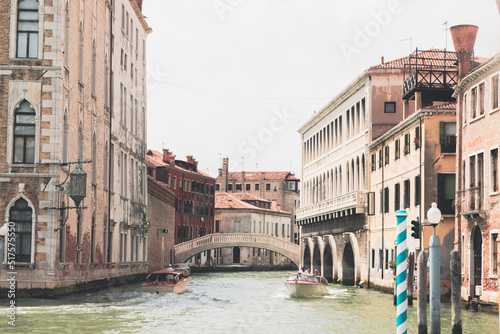 Boats and gondolas passing near Rialto Bridge in Venice