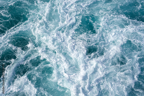 Water abstract background. Cruise ship wake while leaving the pier in Hawaii 