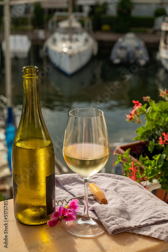 Drinking of cold white wine  with view on yacht harbour of Port Grimaud, summer vacation on French Riviera, France