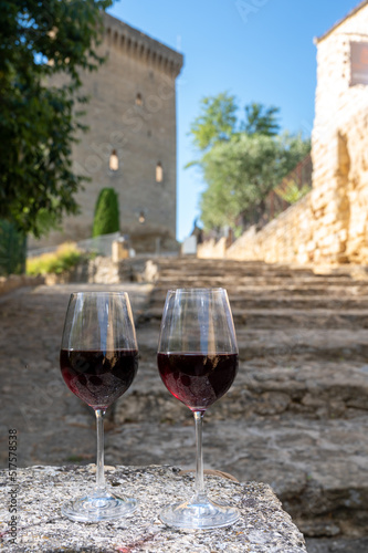 Glass of red dry wine and ruins of medieval castle of Ch  teauneuf-du-Pape ancient wine making village in France