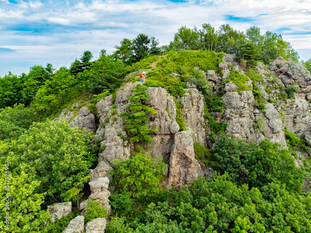 Rocky hill with abundant vegetation. Cedars grow right in the rocky rock. Nature protection zone near Khabarovsk in the Khekhtsir Nature Reserve. A favorite place of tourists is Snake Hill. 