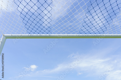 Behind the ropes of the outdoor soccer field goal net, the football goal background