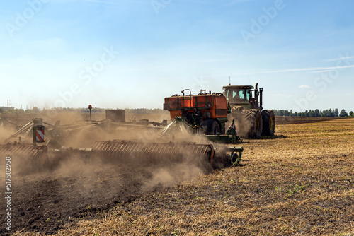 The tractor plows the land. Agriculture image. © Aleksandr Rybalko