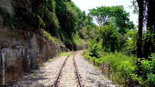 Railway track in a woodland in Death Railway in Kanchanaburi Provice Thailand. photo