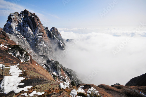 Mountain landscape after heavy snowfall, trees covered with snow and rime, sea of fluffy misty clouds ,China, Anhui Province, Mount Huang