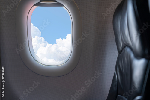 Window View From Passenger Seat On Commercial Airplane. Beautiful view from the window of airplane to blue sky with Passengers flying