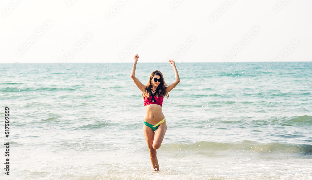 Portrait of smiling fashion woman relaxation on the tropical beach.Happy young beautiful girl enjoying and having fun on the tropical island.Summer vacation and travel Portrait of smiling fashion woman relaxation on the tropical beach.Happy young beautiful girl enjoying and having fun on the tropical island.Summer vacation and travel