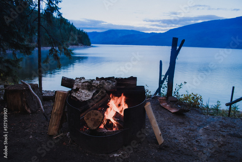 Campfire in the firepit in the campsite at Adams Lake, British Columbia, evening, mountains