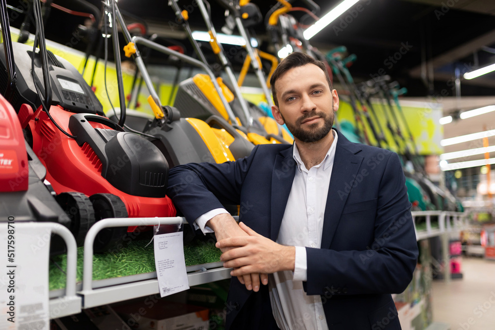 portrait of a manager in a business suit for the sale of gasoline and electric lawn mowers portrait of a manager in a business suit for the sale of gasoline and electric lawn mowers