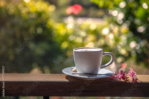 Espresso coffee on wooden table natural background in warm tone garden