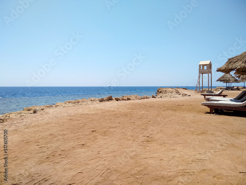 Beautiful view of the sea from a sandy beach with a rocky shore 