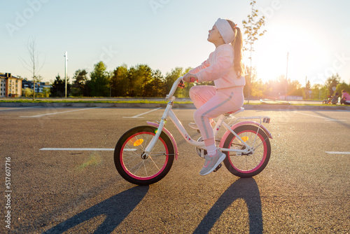 Little girl on a bicycle in summer park. cycling outdoors