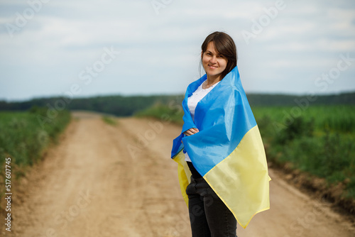 Woman with Ukrainian flag in wheat field.Happy boy celebrating Independence Day. © Ruslan Ivantsov