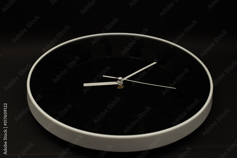 Wall clock on black background, subject photography Wall clock on black background, subject photography