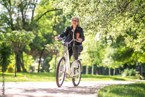 A woman in black jacket on a bike
