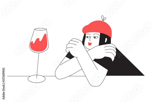 A sad girl is sitting alone with a glass of wine. Depression, loneliness, insecurity wine lover concept.