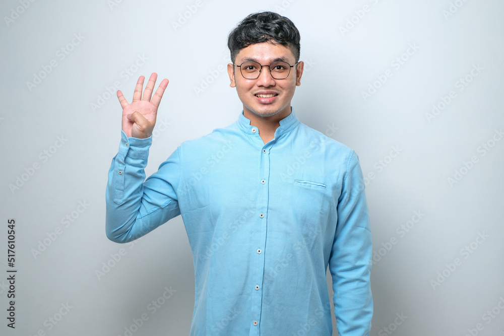 Young asian man wearing casual clothes showing and pointing up with fingers number while smiling confident and happy Young asian man wearing casual clothes showing and pointing up with fingers number while smiling confident and happy