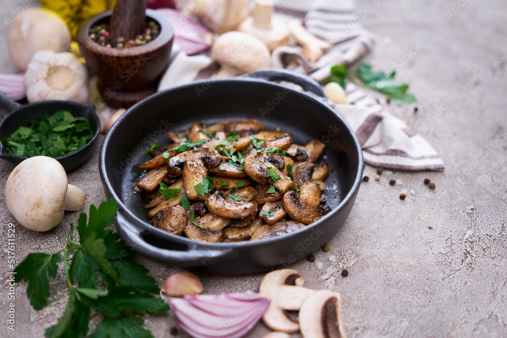 black ceramic bowl with fried mushrooms on grey concrete background black ceramic bowl with fried mushrooms on grey concrete background