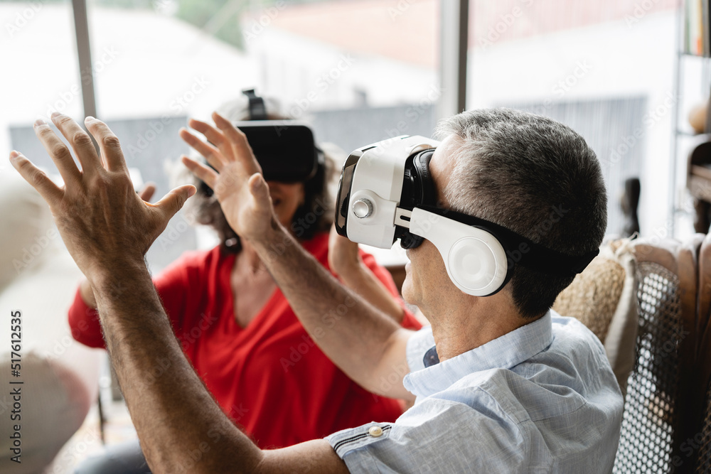 Business colleagues wearing virtual reality simulator gesturing in workplace Business colleagues wearing virtual reality simulator gesturing in workplace