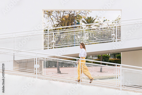 Businesswoman walking on footbridge photo