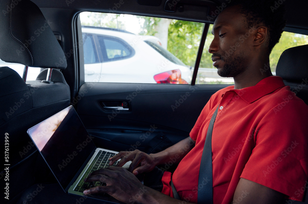 Man on laptop sitting in car Man on laptop sitting in car
