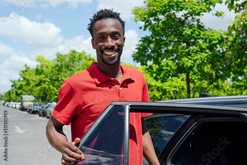 Smiling man getting into car