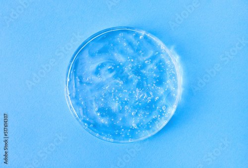 serum gel closeup in petri dish on a blue background 