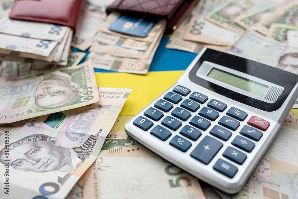 Ukraine national flag with UAH paper money in wallet, credit card calculator, Ukraine national flag with UAH paper money in wallet, credit card calculator,