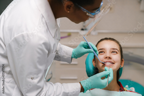 Black dentist working with patient in dental clinic