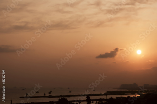 .Sunset on the sea coast in a little fog