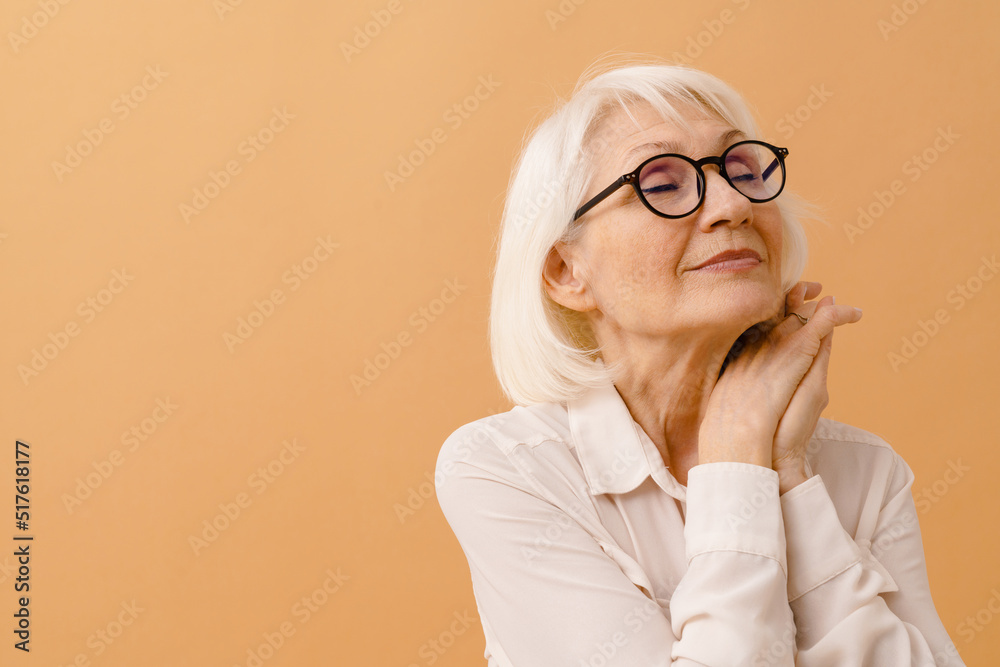 Beautiful dreaming senior woman with folded arms and closed eyes Beautiful dreaming senior woman with folded arms and closed eyes