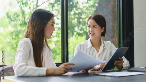 Coworker business concept, Two businesswoman checking report to discussing new project together