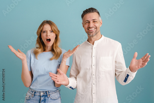 White man and woman expressing surprise and throwing their hands aside