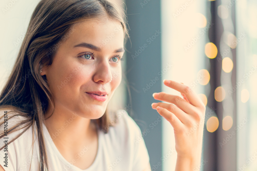 A beautiful blue eyed girl with hand near face. A beautiful blue eyed girl with hand near face.