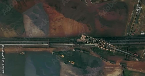 Overhead View Of Excavators Loading Trucks With Coal Near Stacker And Reclaimer. Aerial Shot photo