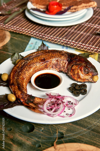 Azerbaijan national cuisine from the chef is called Kutum stuffed fish with fish caviar, nuts and special sauce photo