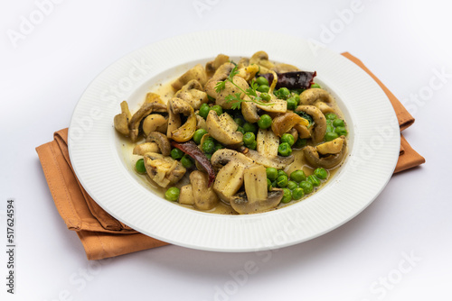 Mushroom and Pea Curry with Roasted Garlic, Indian food served in a bowl
