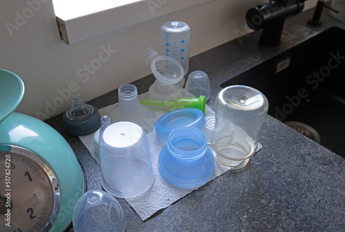Overview of several sterilized bottles and cups for a baby
