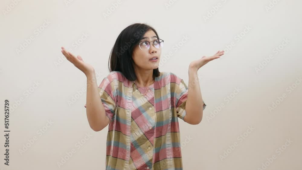 Pretty asian woman pointing fingers left and right, making decision, showing two variants choices Pretty asian woman pointing fingers left and right, making decision, showing two variants choices