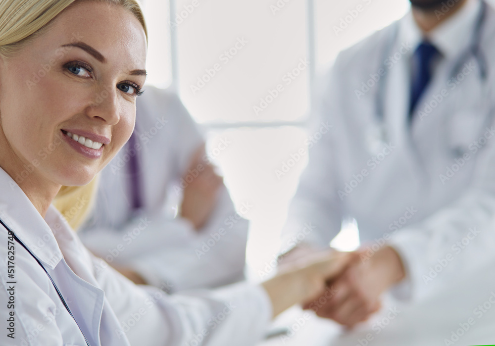 Doctor shaking hands with a male patient in the office Doctor shaking hands with a male patient in the office