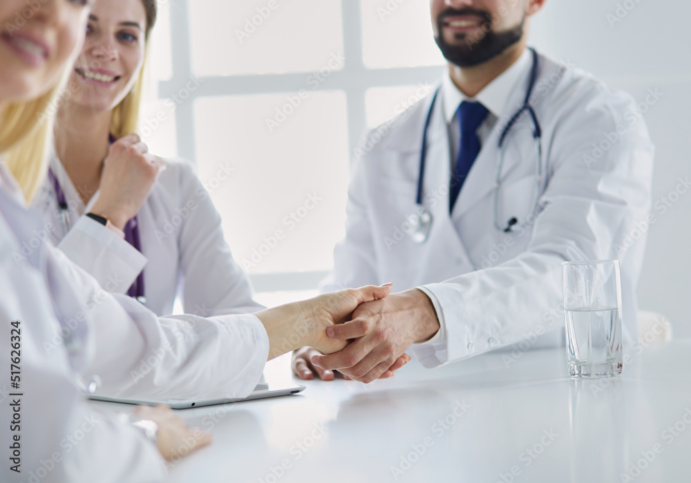 Doctor shaking hands with a male patient in the office Doctor shaking hands with a male patient in the office
