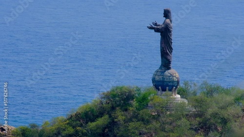 The popular tourism landmark Cristo Rei of Dili Jesus Statue with blue ocean in the capital, Timor Leste, South East Asia photo