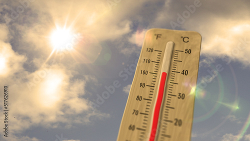 Thermometer on blue sky and shining sun illustration photo