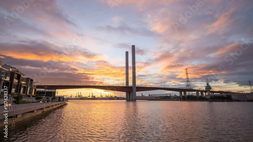 Sunset timelapse video of Bolte Bridge with moving clouds at District Docklands in Melbourne CBD, Australia