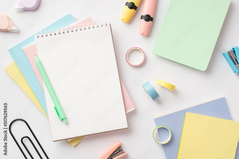 Back to school concept. Top view photo of notebooks pen mini staplers adhesive tape round correction tape and markers on isolated white background with blank space