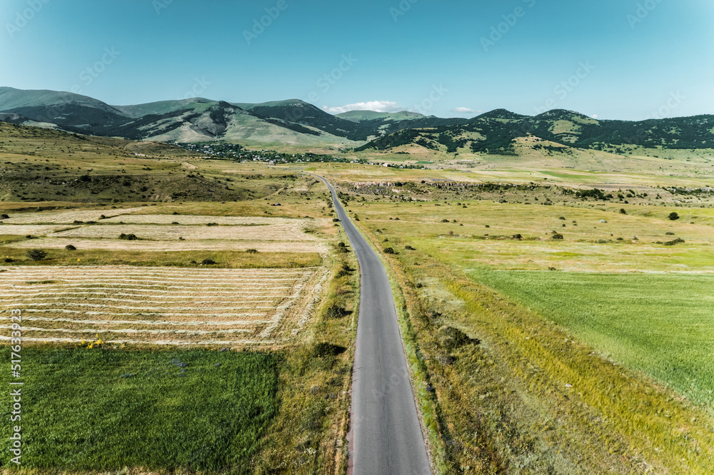 A beautiful tranquil scene of gorgeous landscape in Armenia, Buzhakan village with beautiful highlands, villages and roadway