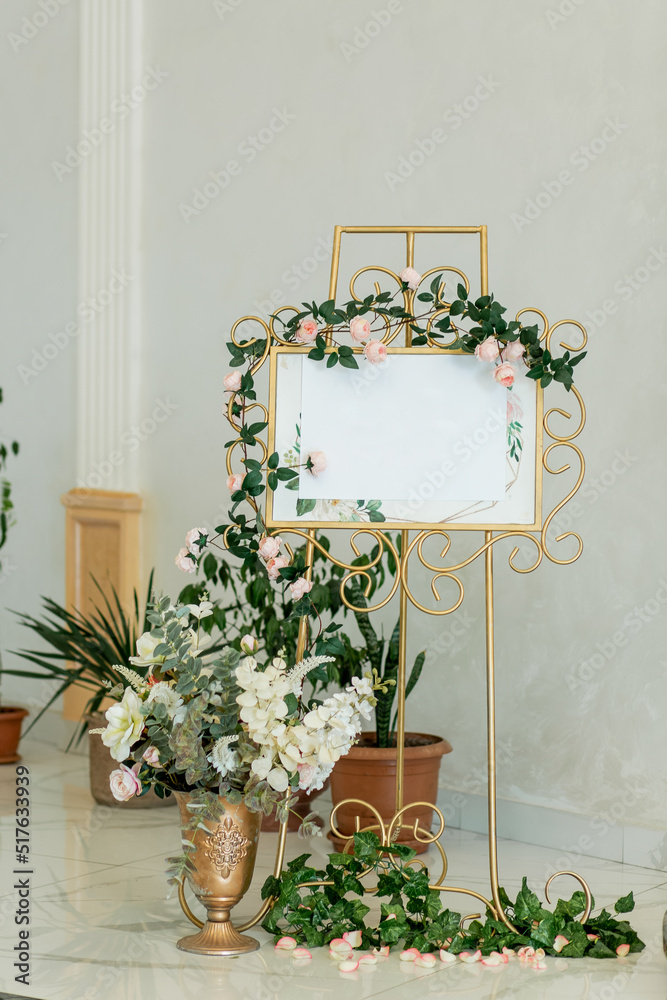 Engagement or wedding floral gold coloured welcome board and easel in banquet hall