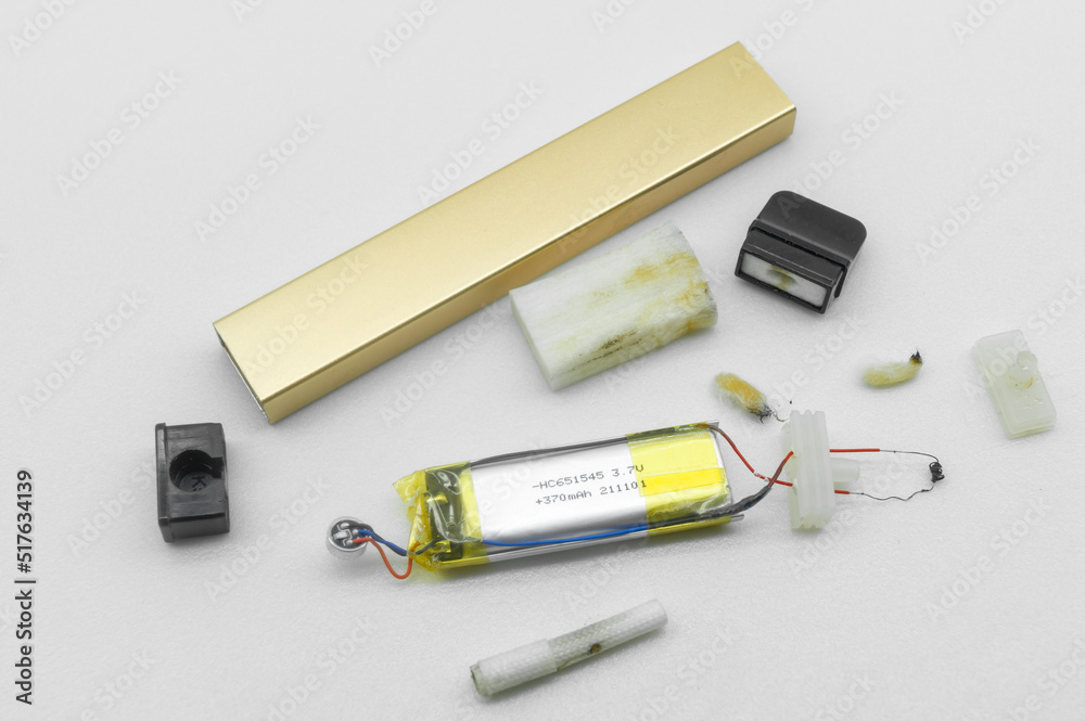 Disassembled into individual parts electronic cigarette. The internal device of the electronic cigarette. Vape device. Selective focus Disassembled into individual parts electronic cigarette. The internal device of the electronic cigarette. Vape device. Selective focus
